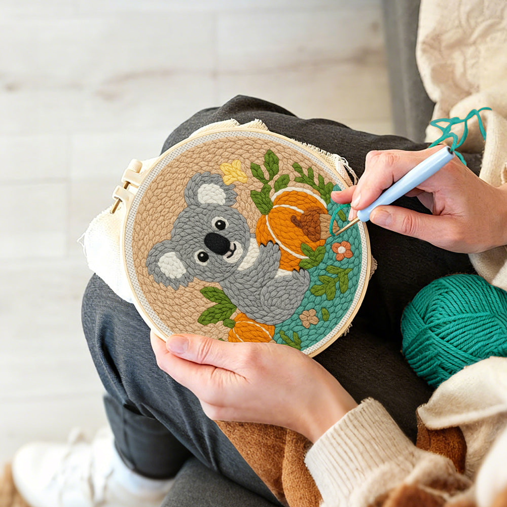 Creating handmade koala and pumpkins in autumn punch needle artwork