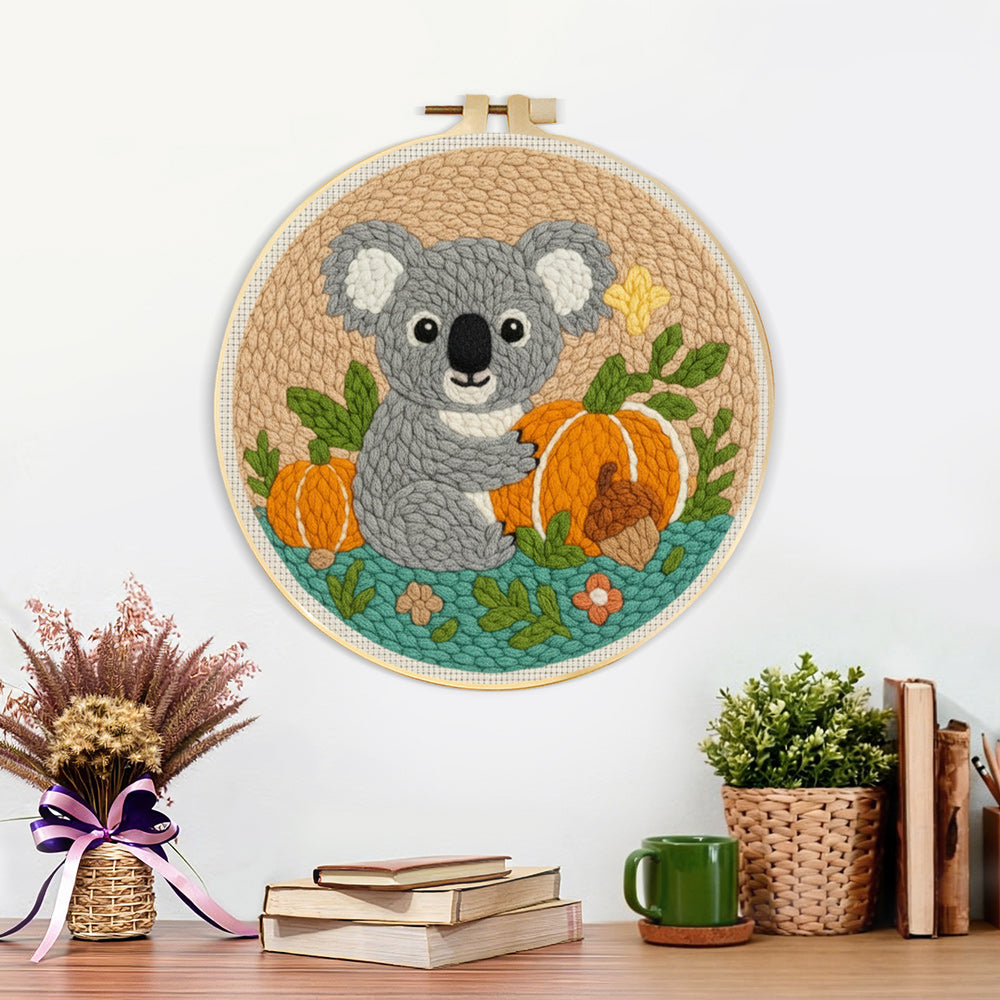 Finished koala and pumpkins in autumn artwork displayed on a wall