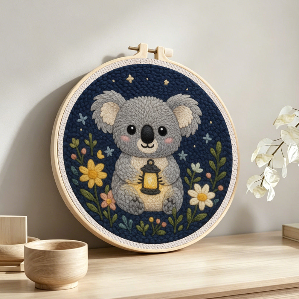 Koala and wildflowers punch needle artwork displayed on a table