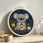 Koala and wildflowers punch needle artwork displayed on a table