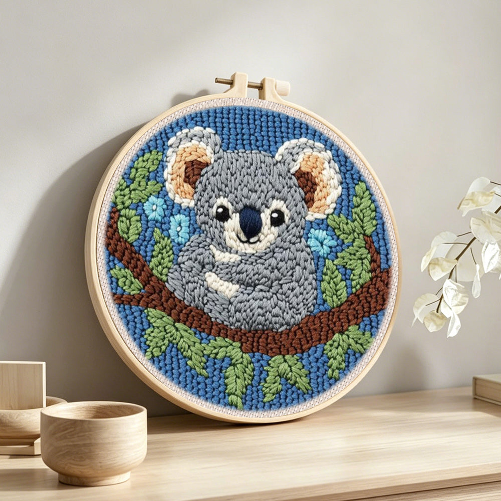 Koala on a tree branch punch needle artwork displayed on a table