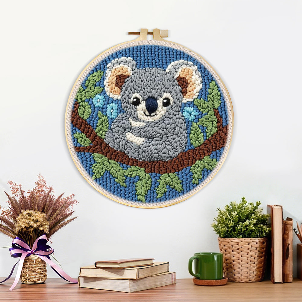 Finished koala on a tree branch artwork displayed on a wall