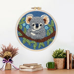 Finished koala on a tree branch artwork displayed on a wall