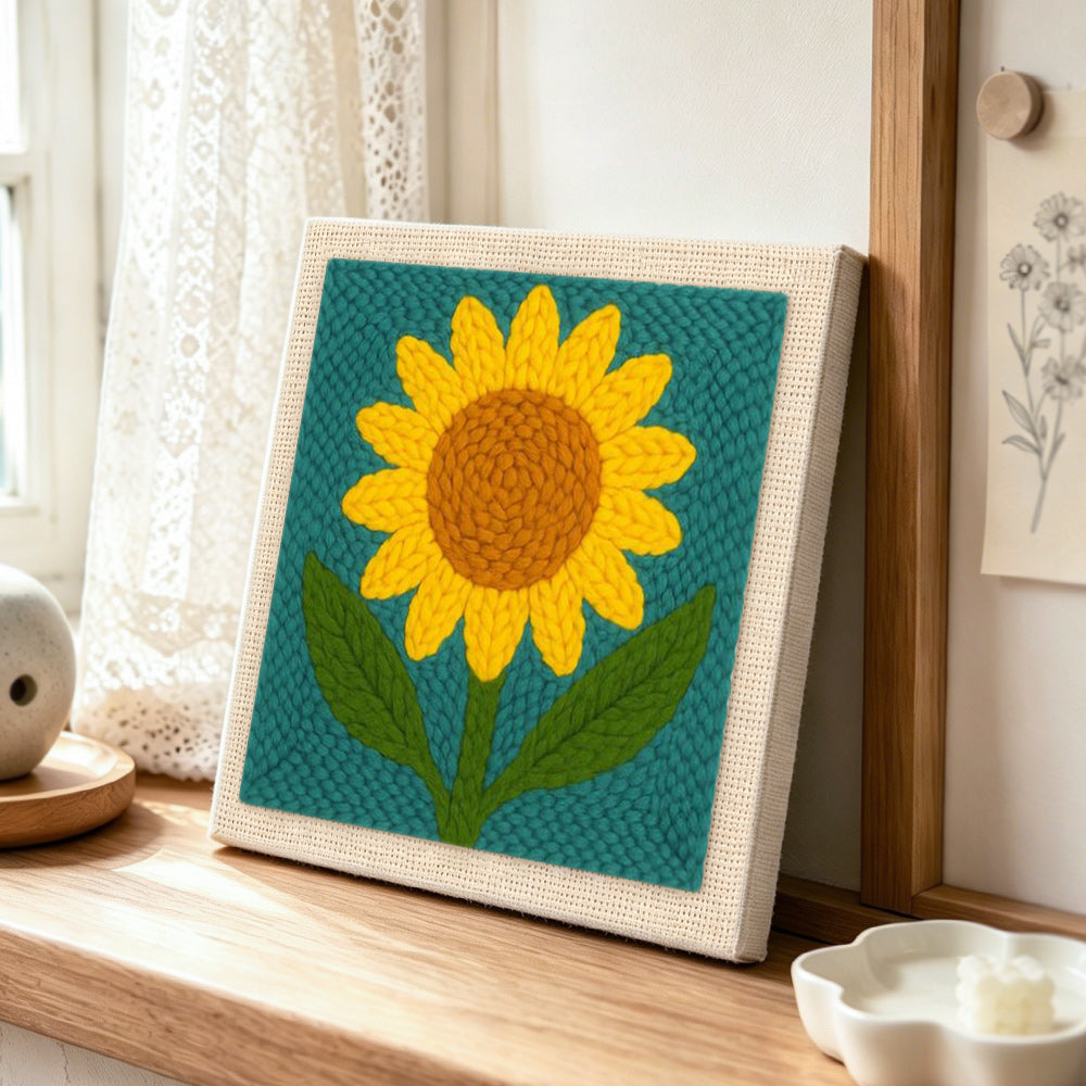 Large single sunflower punch needle artwork displayed on a table