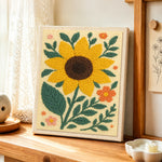 Large sunflower and ditsy florals punch needle artwork displayed on a table