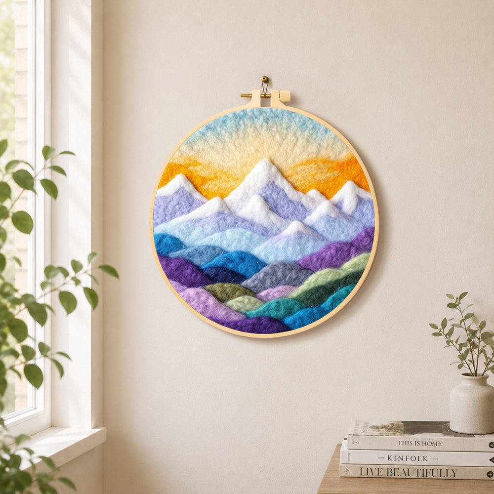 Layered colourful mountain peaks at sunrise needle felt wall art displayed in a bright home interior