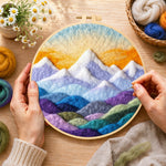 Creating the layered colourful mountain peaks at sunrise wool painting by hand with a felting needle