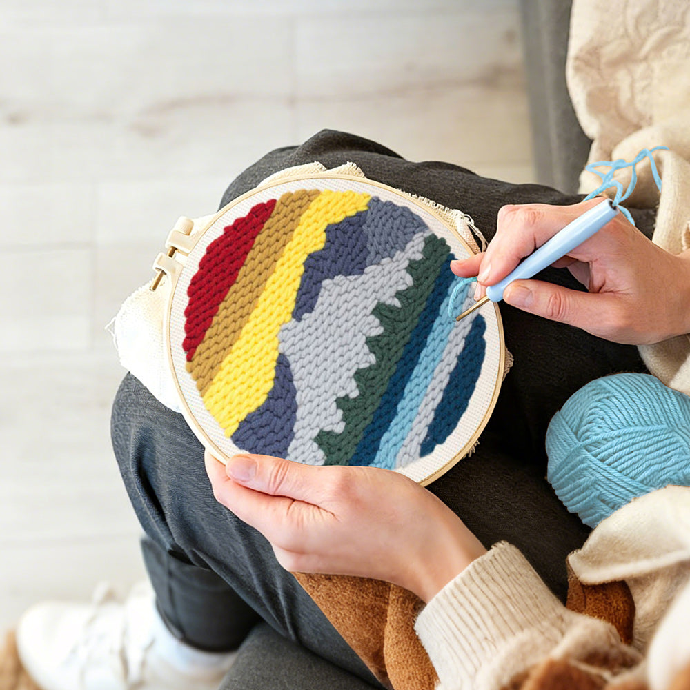 Creating handmade layered mountain landscape punch needle artwork
