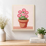 Finished layered pink flowers in pot artwork displayed on a wall