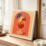Layered tropical cocktail punch needle artwork displayed on a table
