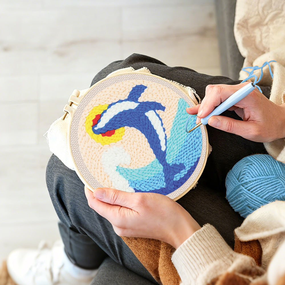 Creating handmade leaping dolphin and waves punch needle artwork