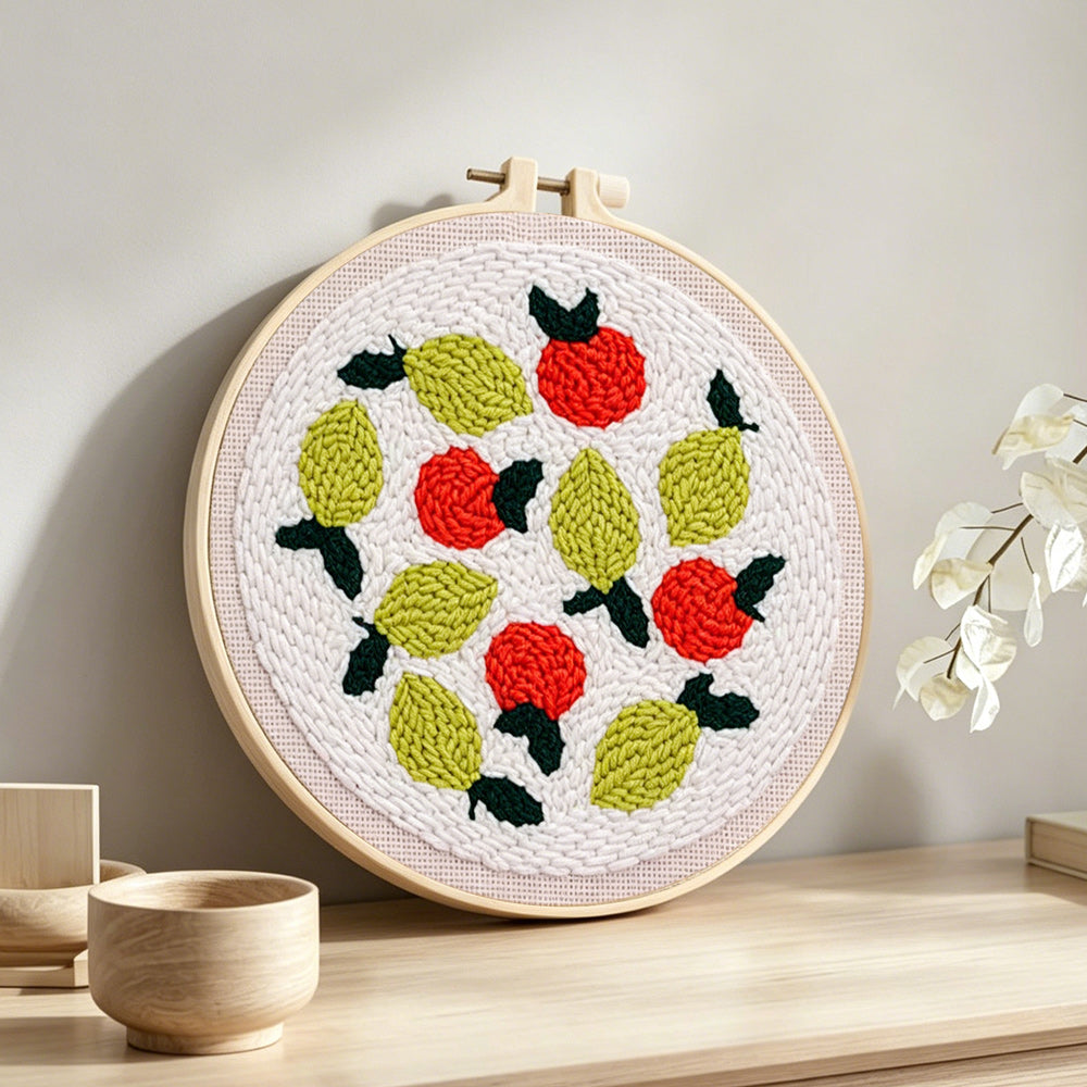 Lemons and red berries punch needle artwork displayed on a table