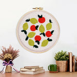 Finished lemons and red berries artwork displayed on a wall