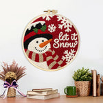 Finished “let it snow” snowman with scarf artwork displayed on a wall
