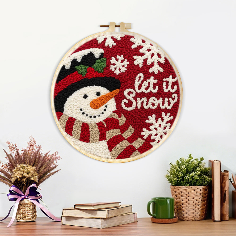 Finished “let it snow” snowman with scarf artwork displayed on a wall