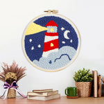 Finished lighthouse at night artwork displayed on a wall
