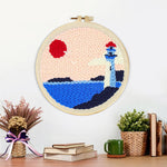 Finished lighthouse by the sea artwork displayed on a wall