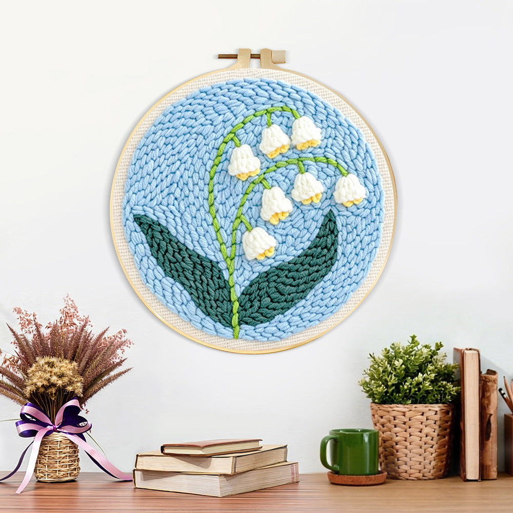 Finished lily of the valley artwork displayed on a wall