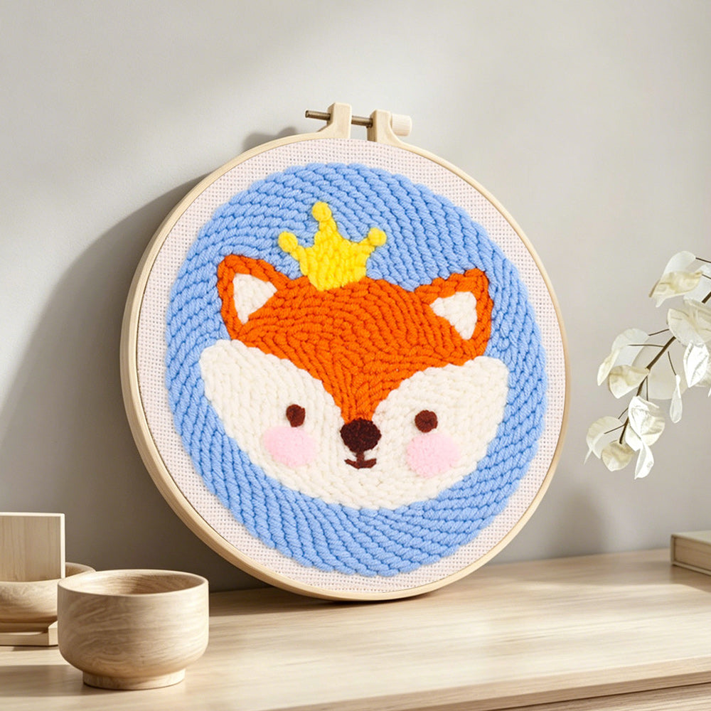 Little crown fox punch needle artwork displayed on a table