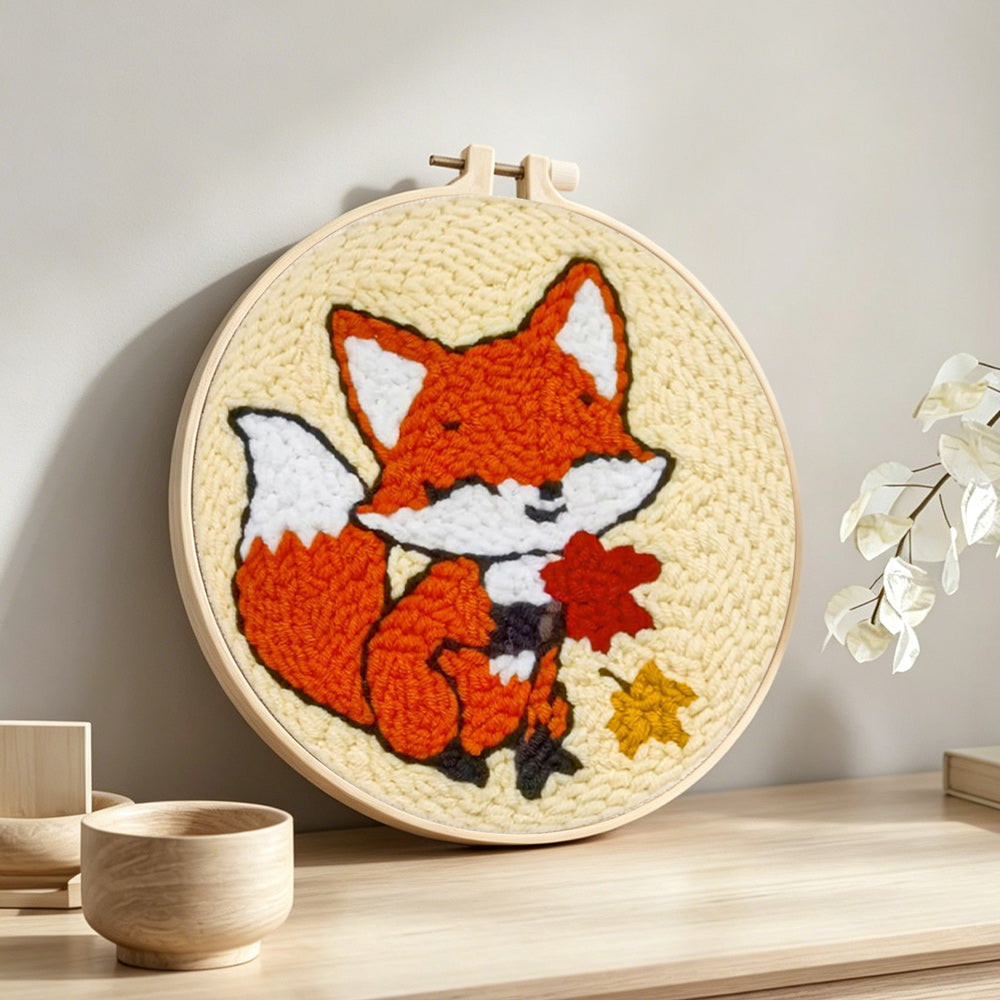 Little fox and maple leaves punch needle artwork displayed on a table