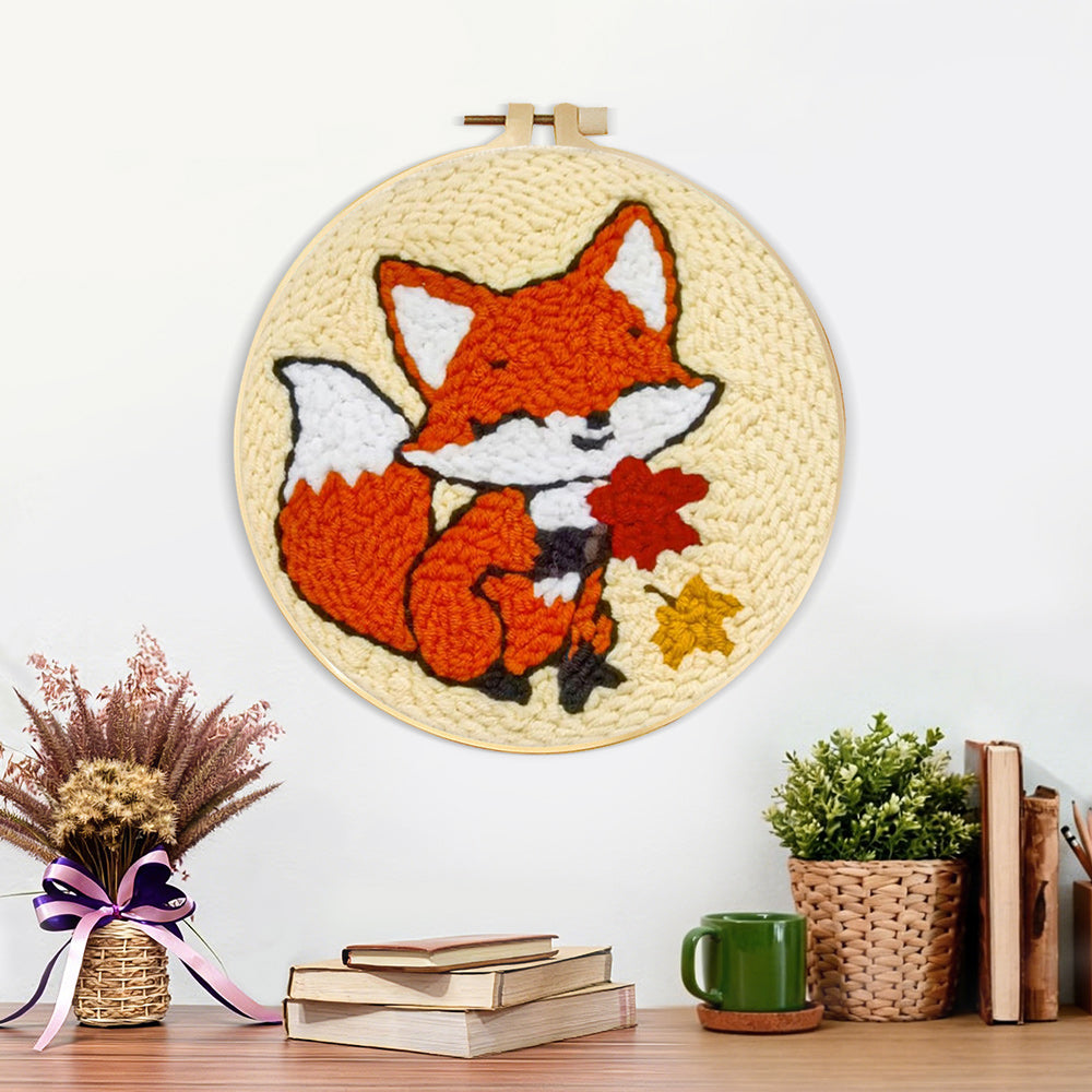 Finished little fox and maple leaves artwork displayed on a wall