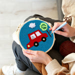 Creating handmade little red car with tree punch needle artwork