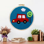 Finished little red car with tree artwork displayed on a wall