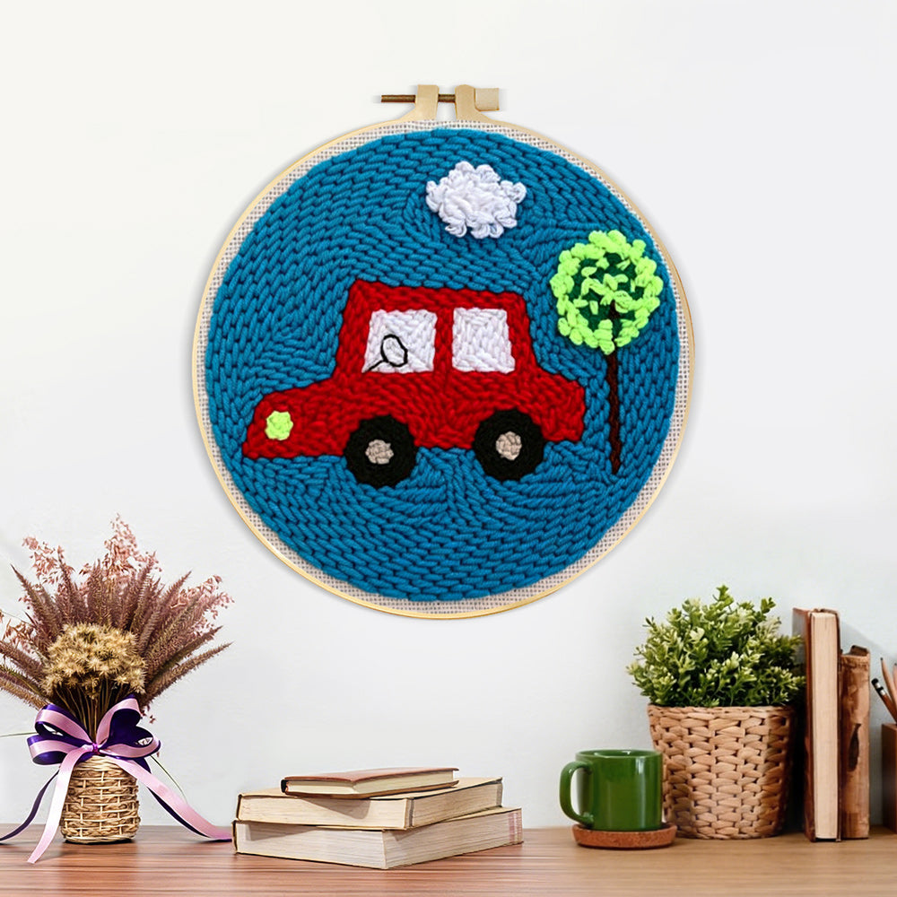 Finished little red car with tree artwork displayed on a wall