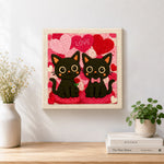 Finished "LOVE" black cat couple with rose artwork displayed on a wall
