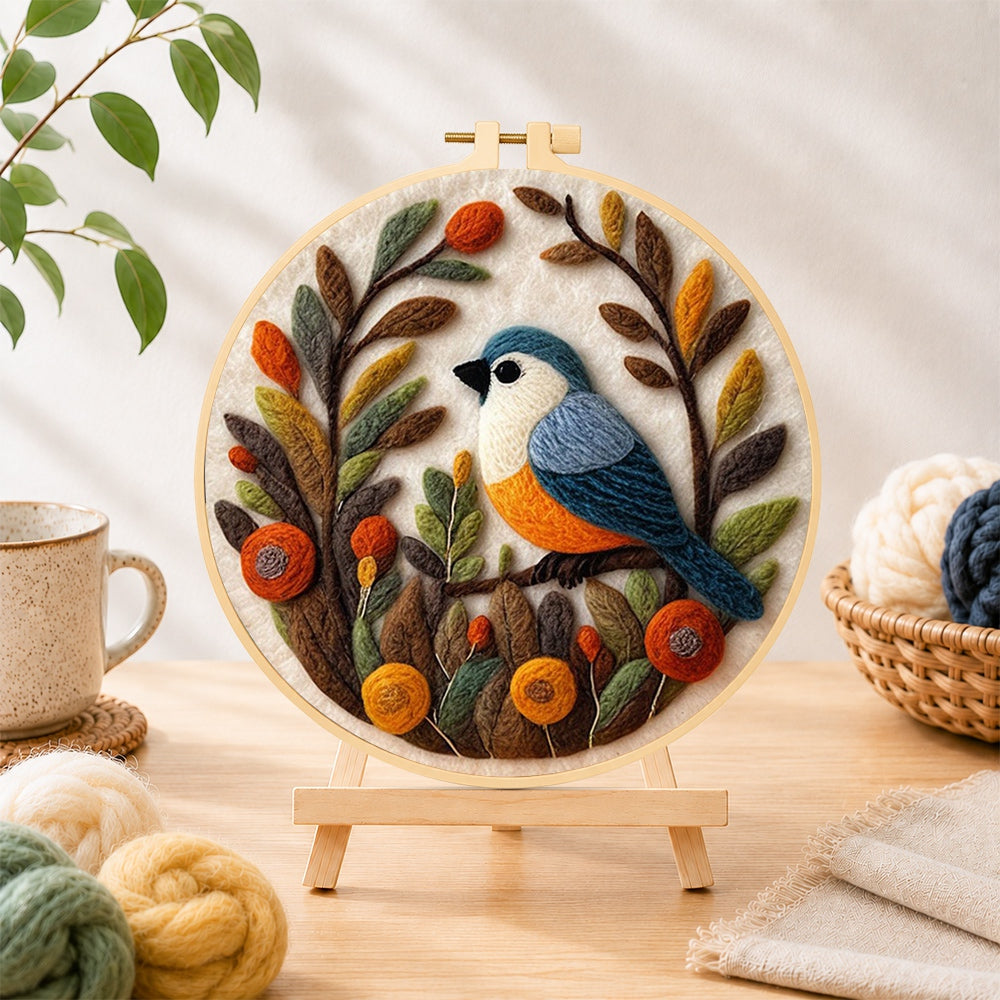 Finished lovely bird in autumn foliage needle felting displayed on a wooden easel