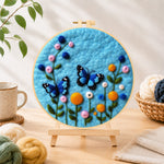Finished lovely blue butterflies and flowers needle felting displayed on a wooden easel