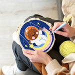 Creating handmade lovely space bear on a moon swing punch needle artwork