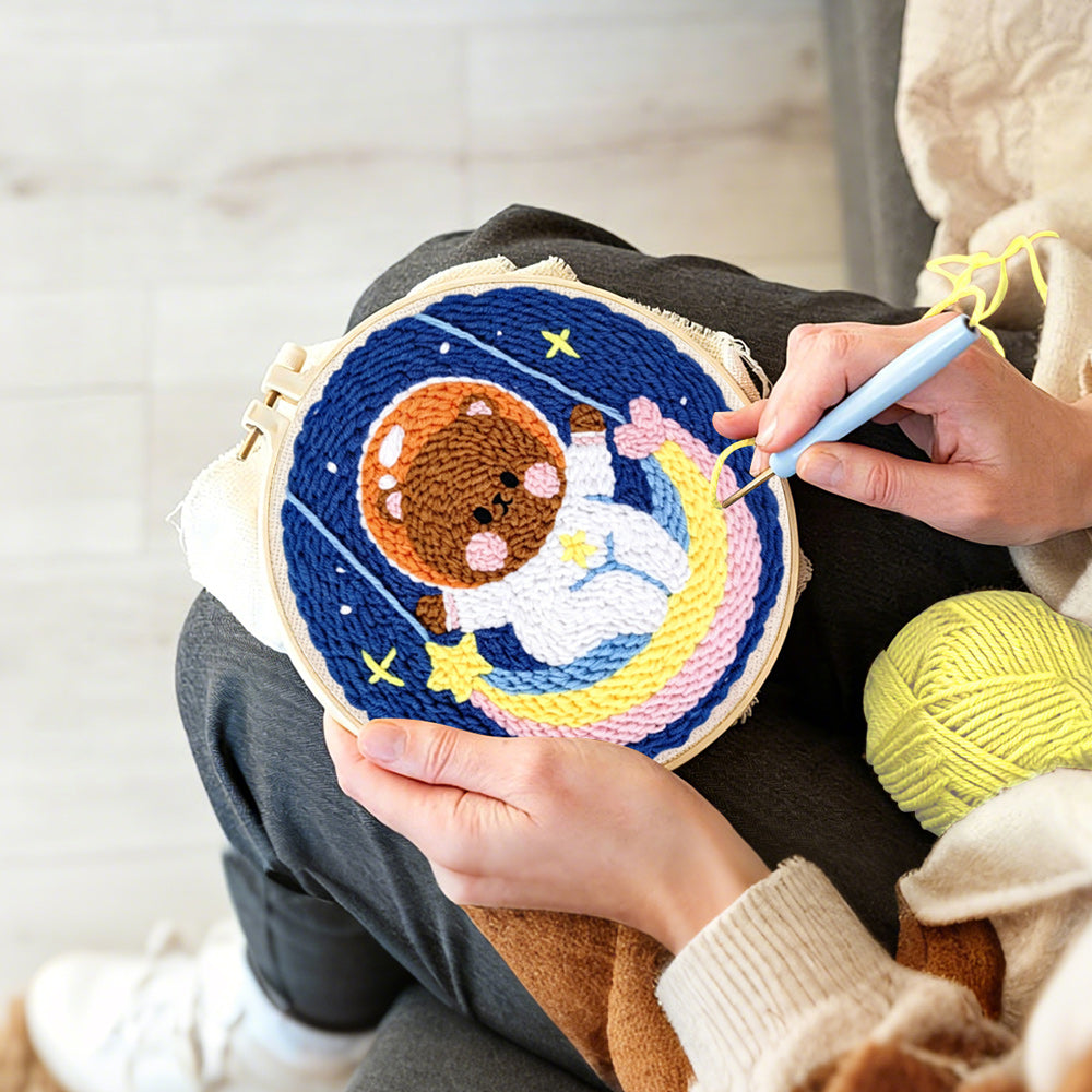 Creating handmade lovely space bear on a moon swing punch needle artwork