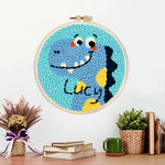 Finished lucky blue dinosaur artwork displayed on a wall