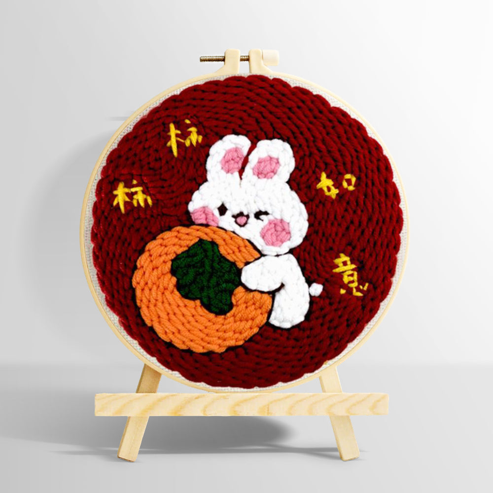 Lucky bunny hugging an orange punch needle kit for beginners