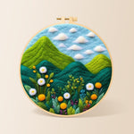 Lush green mountains and wildflowers needle felting kit for beginners with a round wooden frame