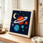 Magical and colourful solar system punch needle artwork displayed on a table