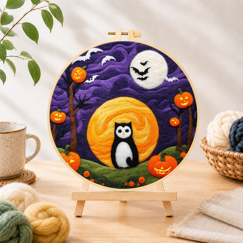 Finished magical black cat and double moons needle felting displayed on a wooden easel