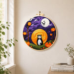 Magical black cat and double moons needle felt wall art displayed in a bright home interior