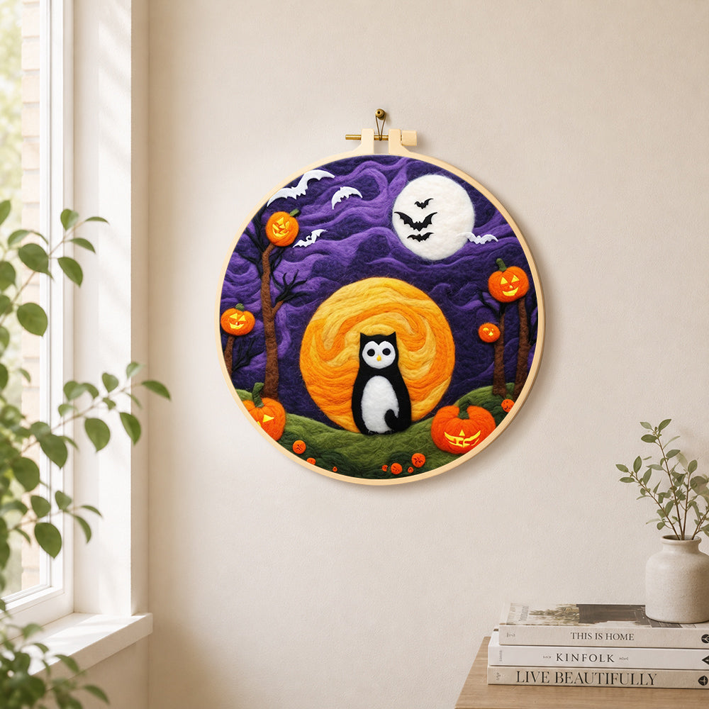 Magical black cat and double moons needle felt wall art displayed in a bright home interior