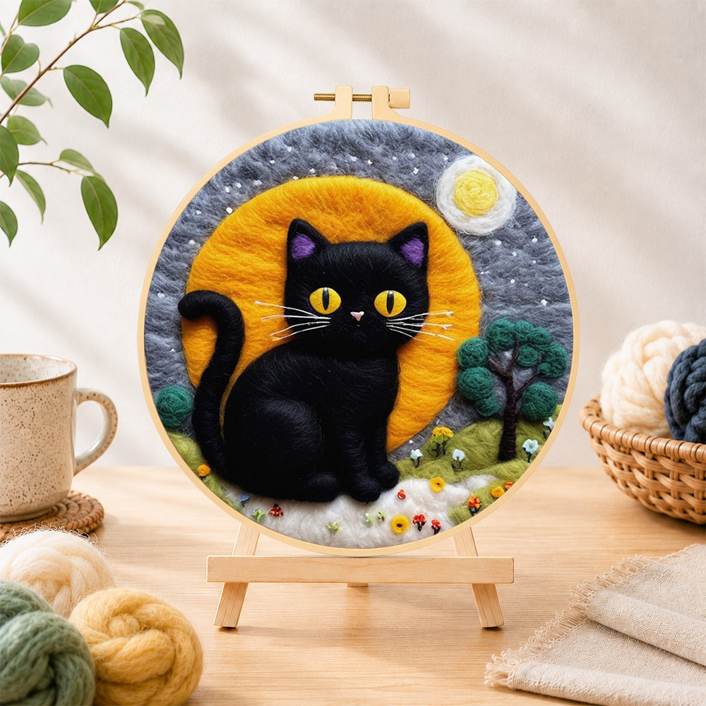Finished magical black cat under the moon needle felting displayed on a wooden easel