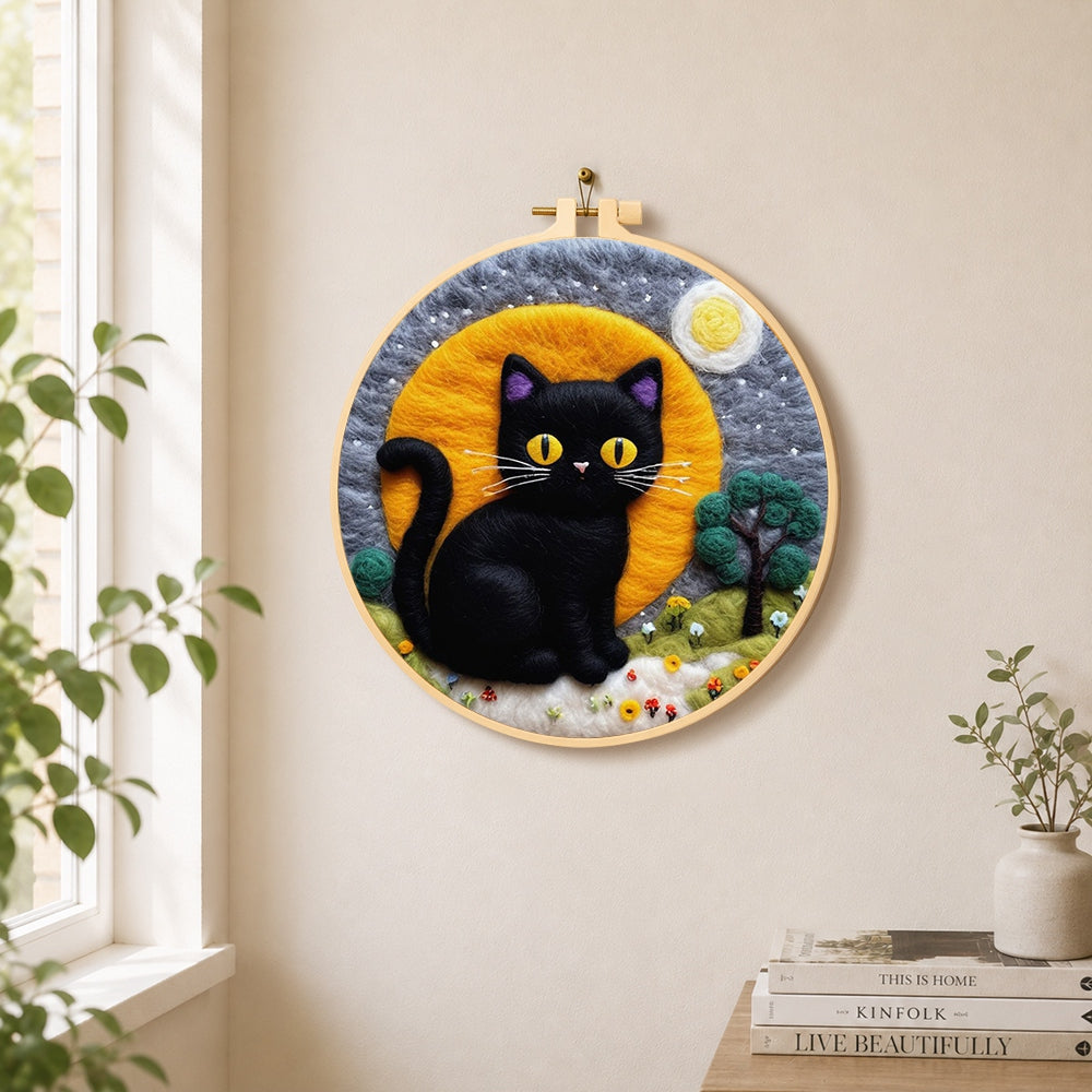 Magical black cat under the moon needle felt wall art displayed in a bright home interior