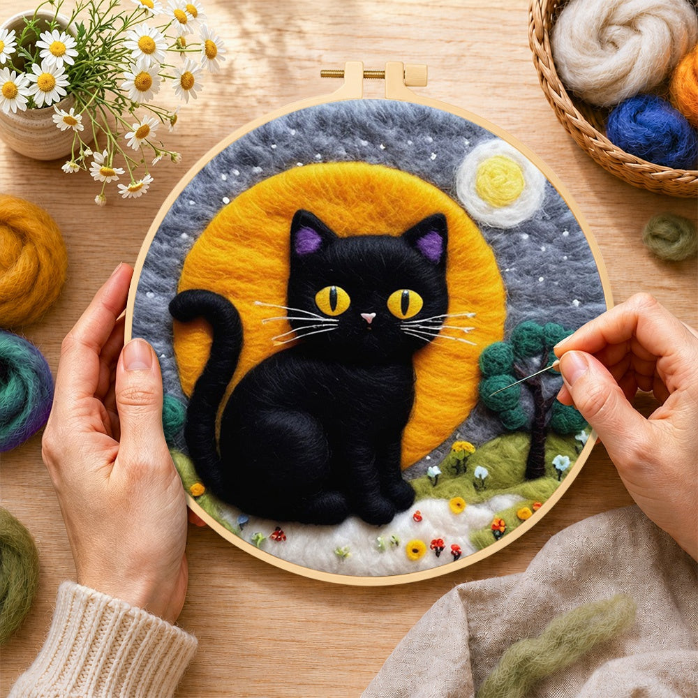 Creating the magical black cat under the moon wool painting by hand with a felting needle