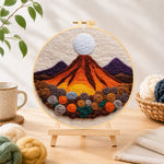 Finished magma volcano and roses needle felting displayed on a wooden easel