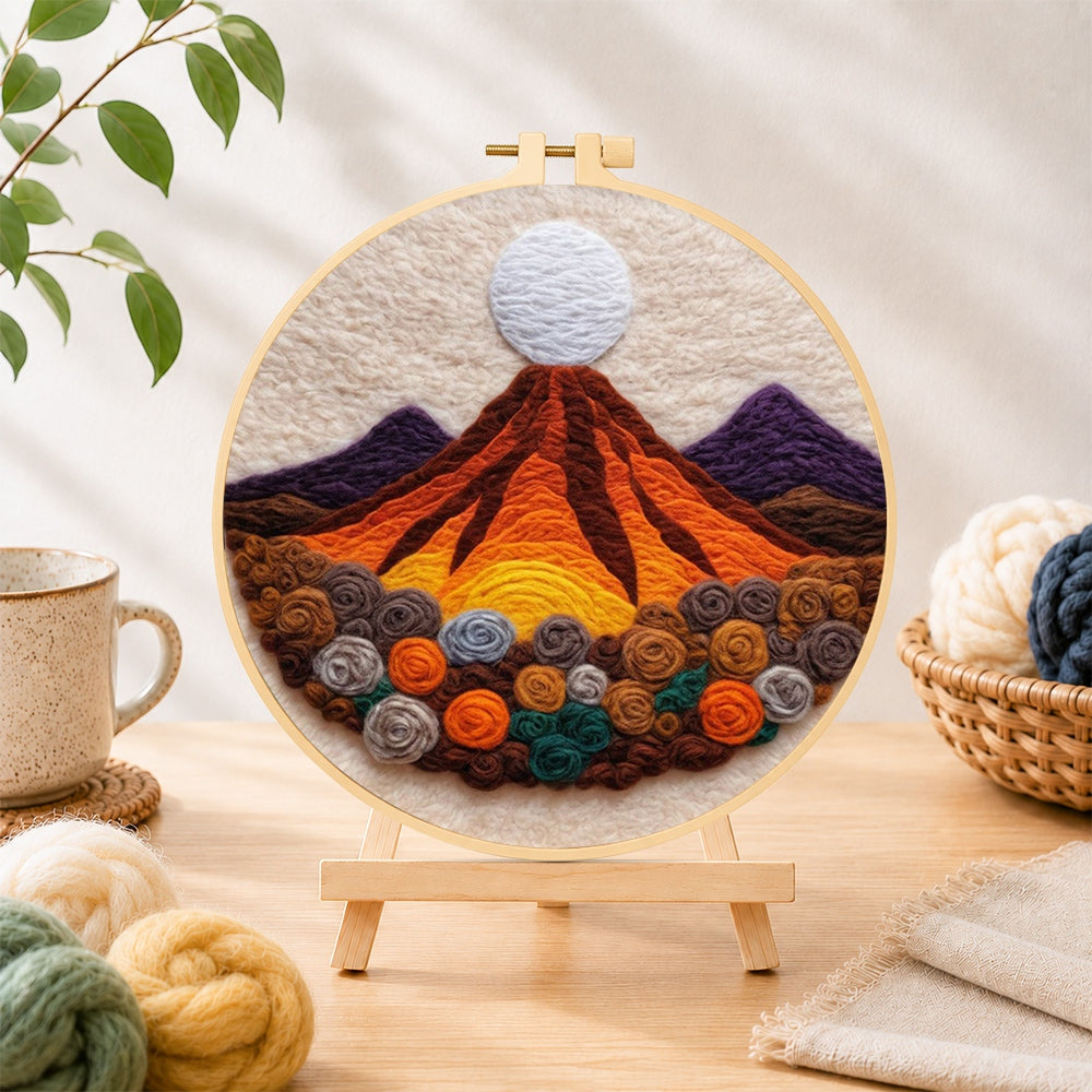 Finished magma volcano and roses needle felting displayed on a wooden easel