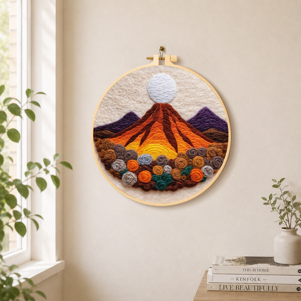 Magma volcano and roses needle felt wall art displayed in a bright home interior