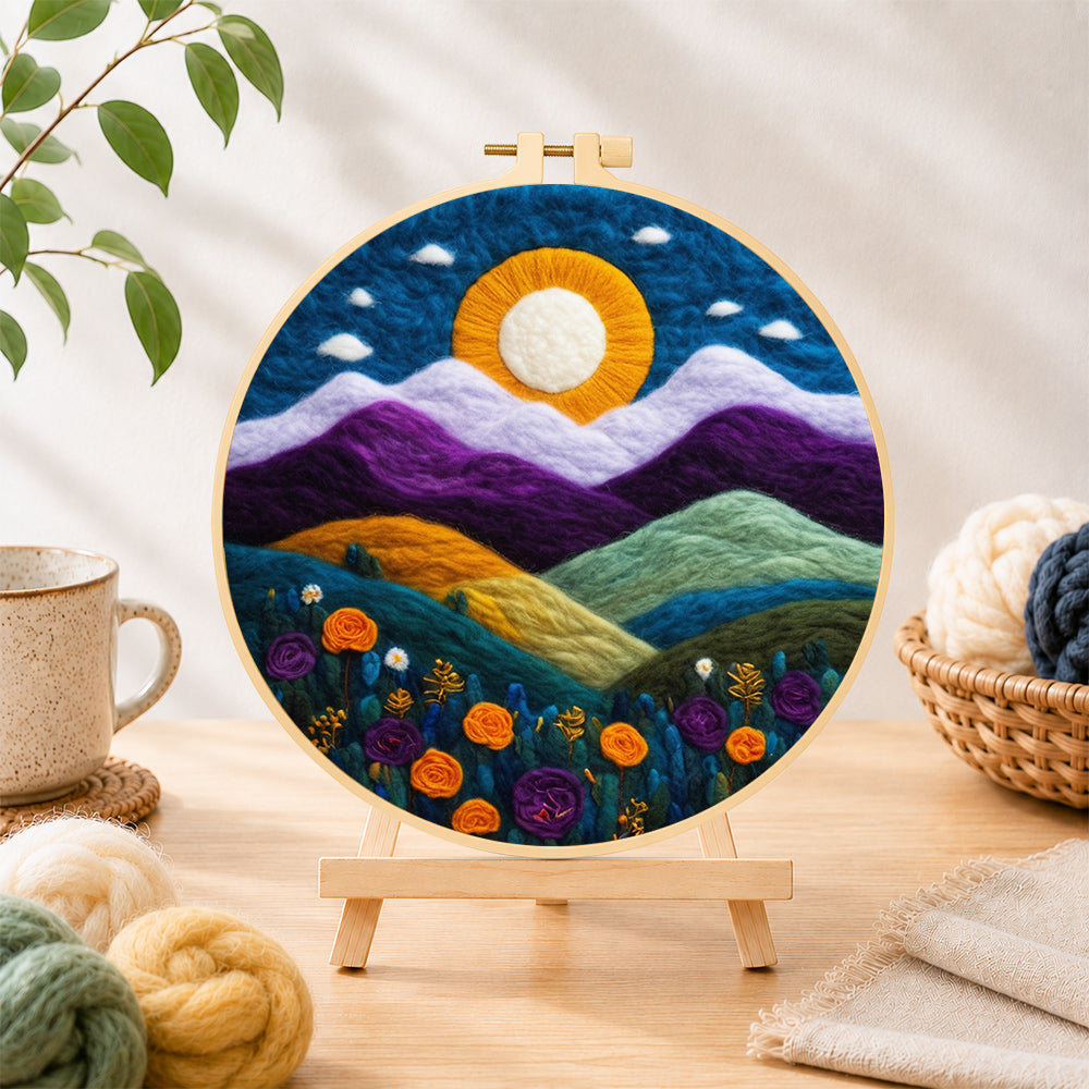 Finished magnificent mountains and sunset needle felting displayed on a wooden easel