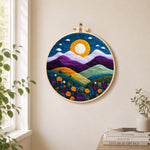 Magnificent mountains and sunset needle felt wall art displayed in a bright home interior