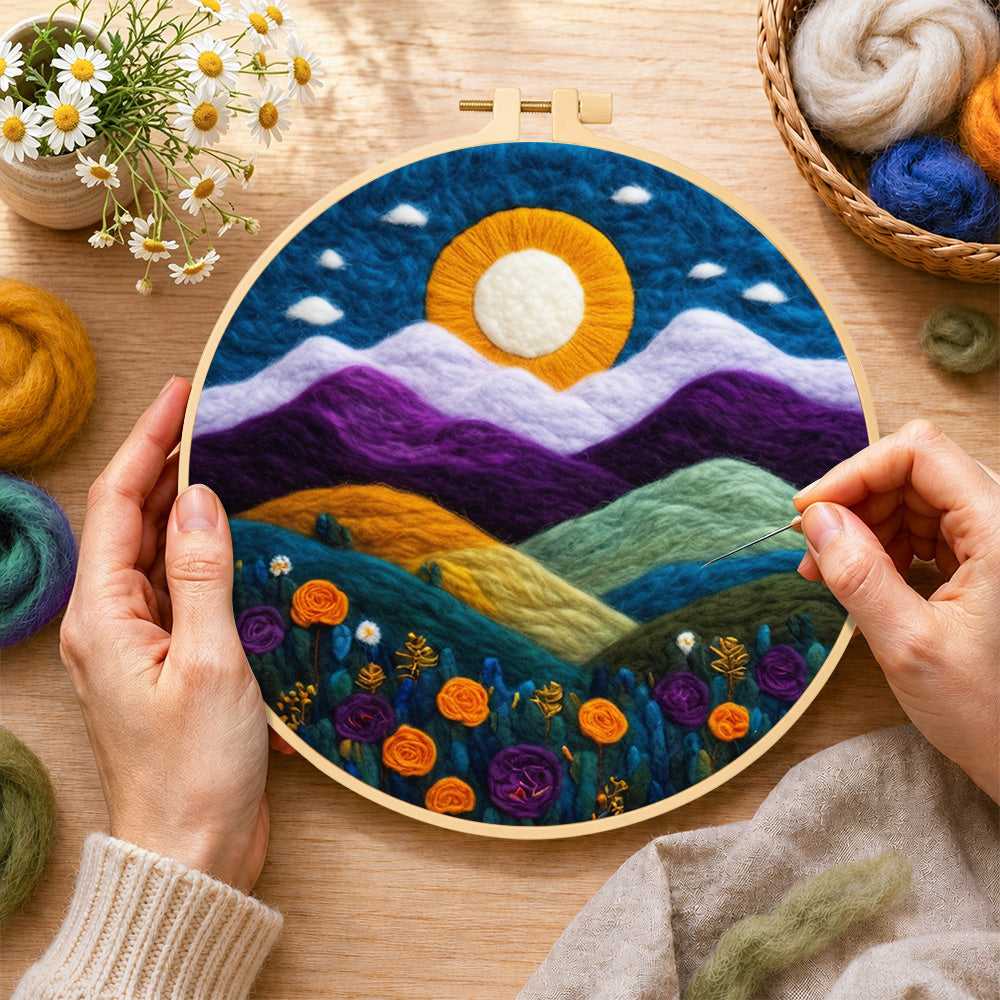 Creating the magnificent mountains and sunset wool painting by hand with a felting needle