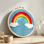 Magnificent rainbow in the blue sky punch needle artwork displayed on a table